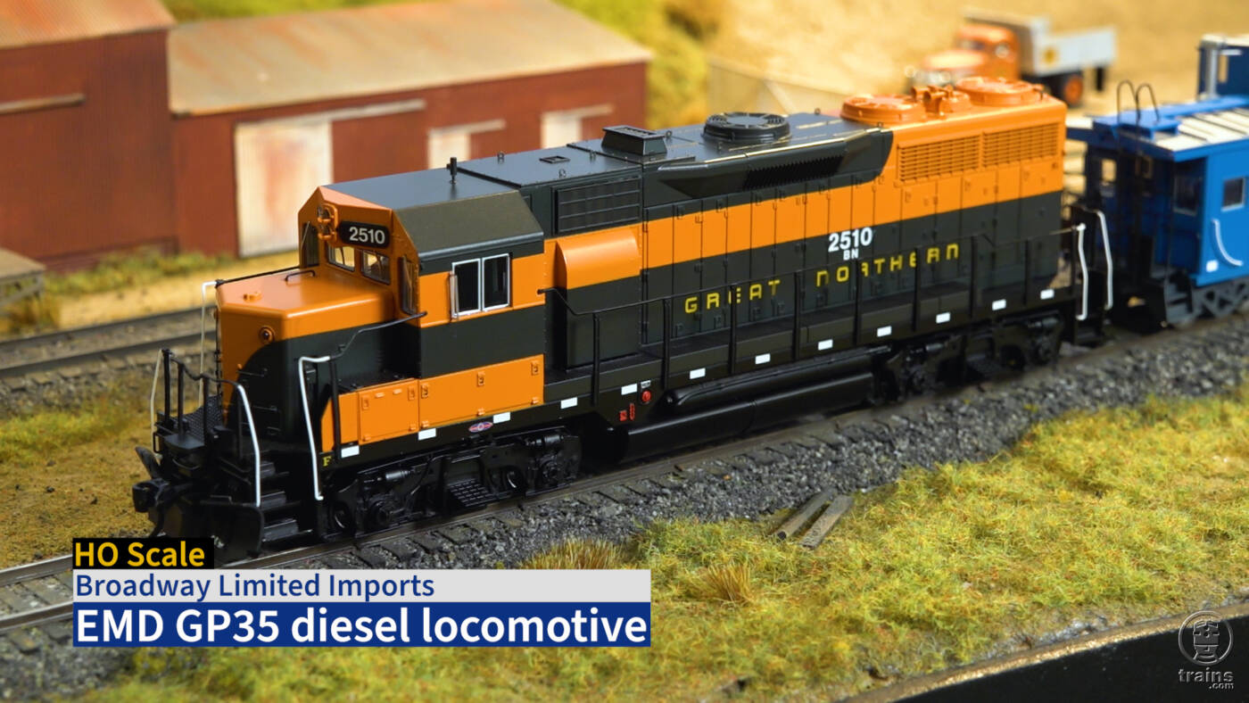 Screen capture from Product Review video showing HO scale diesel painted orange and green.